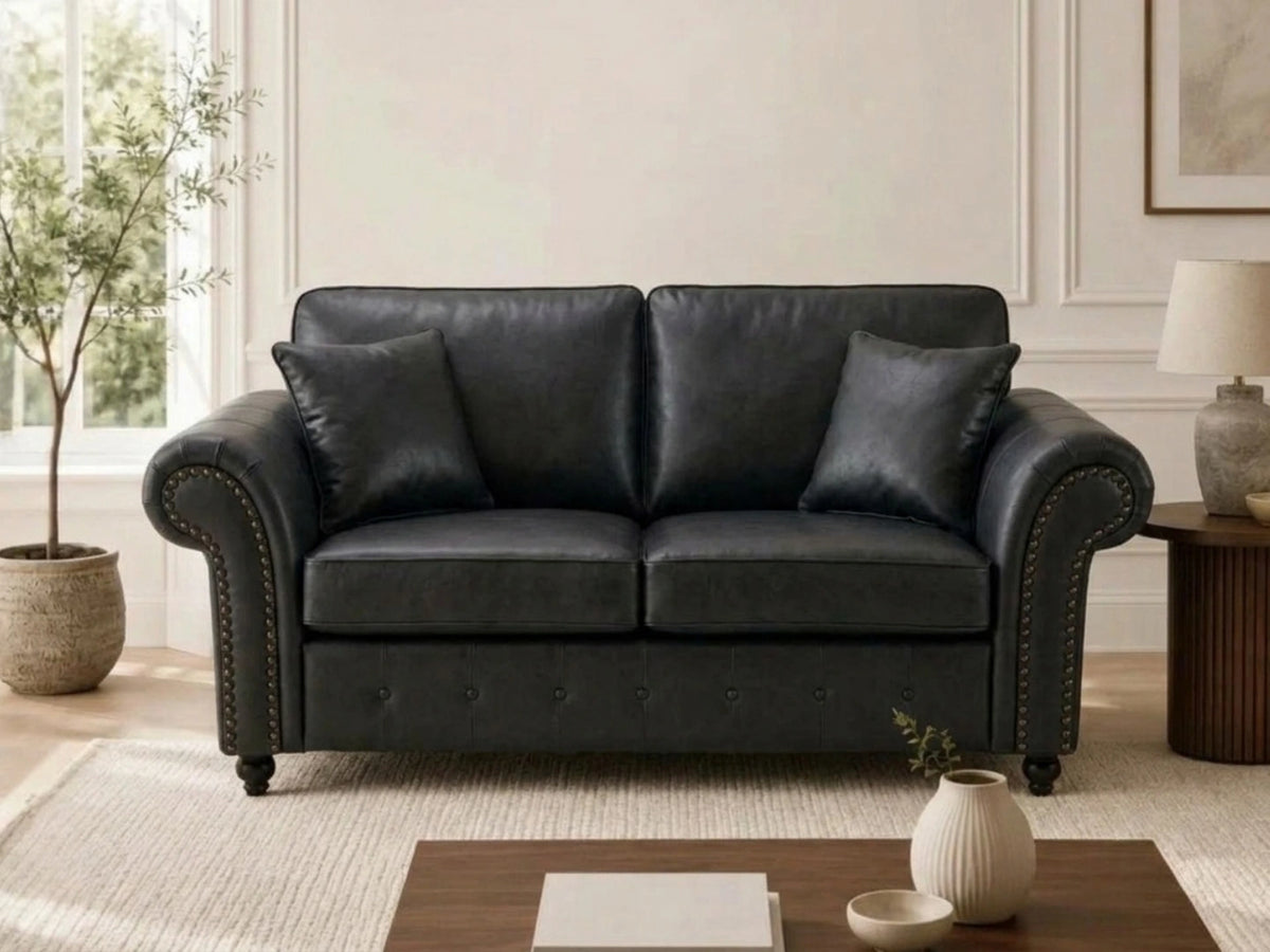 Black leather Gamzo Outlet Oakland full back 2-seater sofa with plush cushions and wooden legs for comfortable seating.