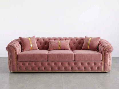 Pink Chesterfield sofa set with three seats, featuring classic button-tufted upholstery and rolled arms in a stylish living room setting.
