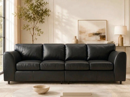 Black Dillon full back 4-seater leather sofa by Gamzo Outlet, showcasing plush cushions and sleek armrests in a modern living room setting.