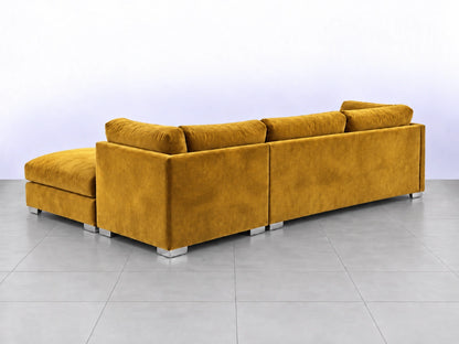 Mustard-colored U-shaped sofa by Gamzo Outlet, featuring plush fabric and modern design, displayed in a spacious living room setting.