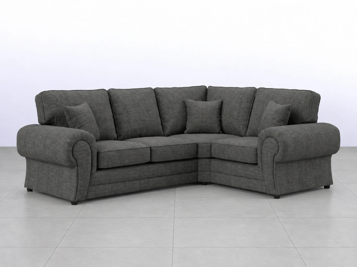 Grey fabric L-shaped sofa from Gamzo Outlet, showing plush cushions and modern design in a cozy living room setting.