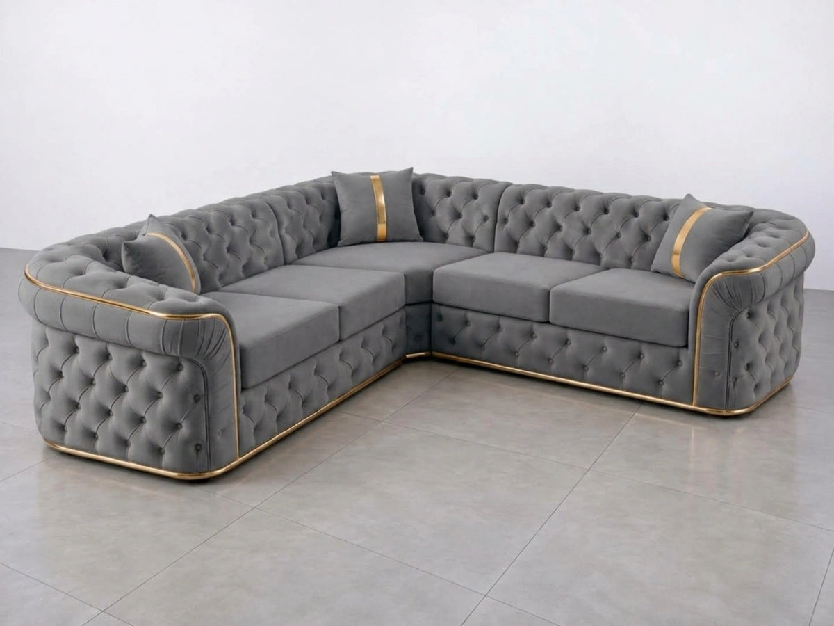 Light grey Chesterfield corner sofa by Gamzo Outlet, featuring tufted upholstery and plush cushions in a stylish living room setting.