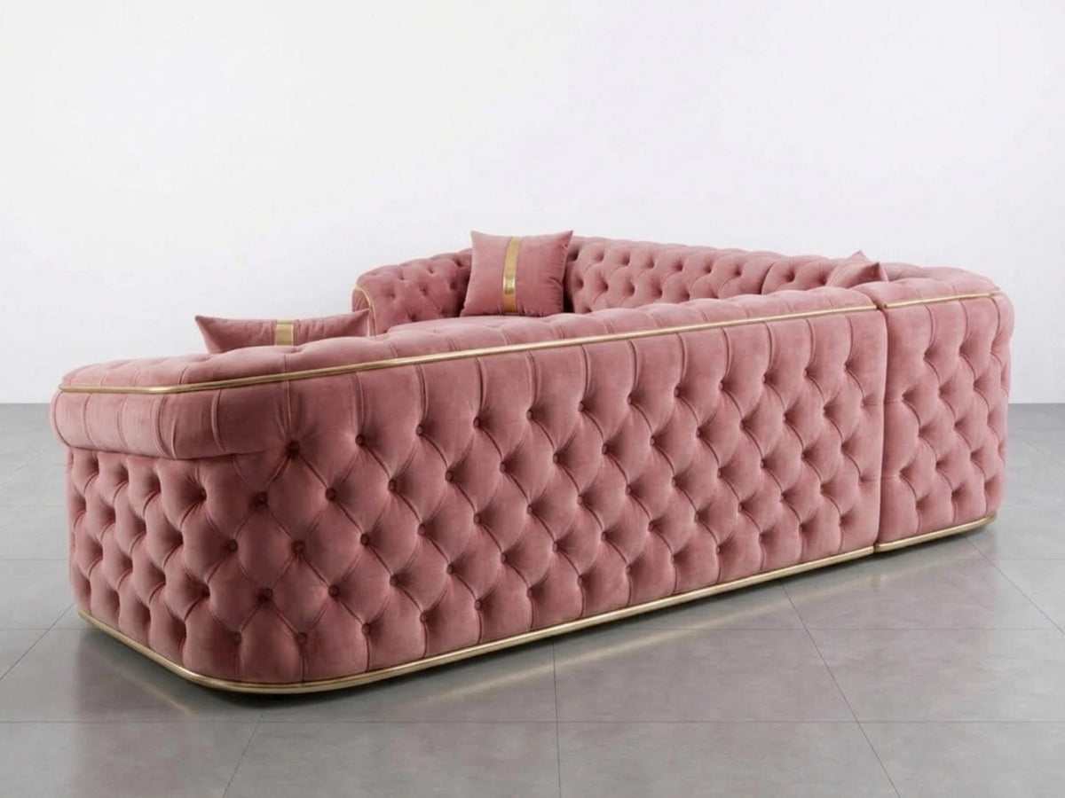 Pink Chesterfield corner sofa by Gamzo Outlet with tufted upholstery and rolled arms, shown in a cozy living room setting.