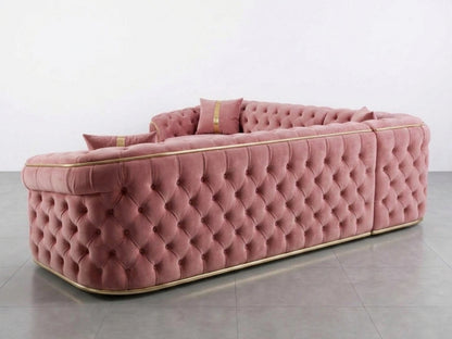 Pink Chesterfield corner sofa by Gamzo Outlet with tufted upholstery and rolled arms, shown in a cozy living room setting.